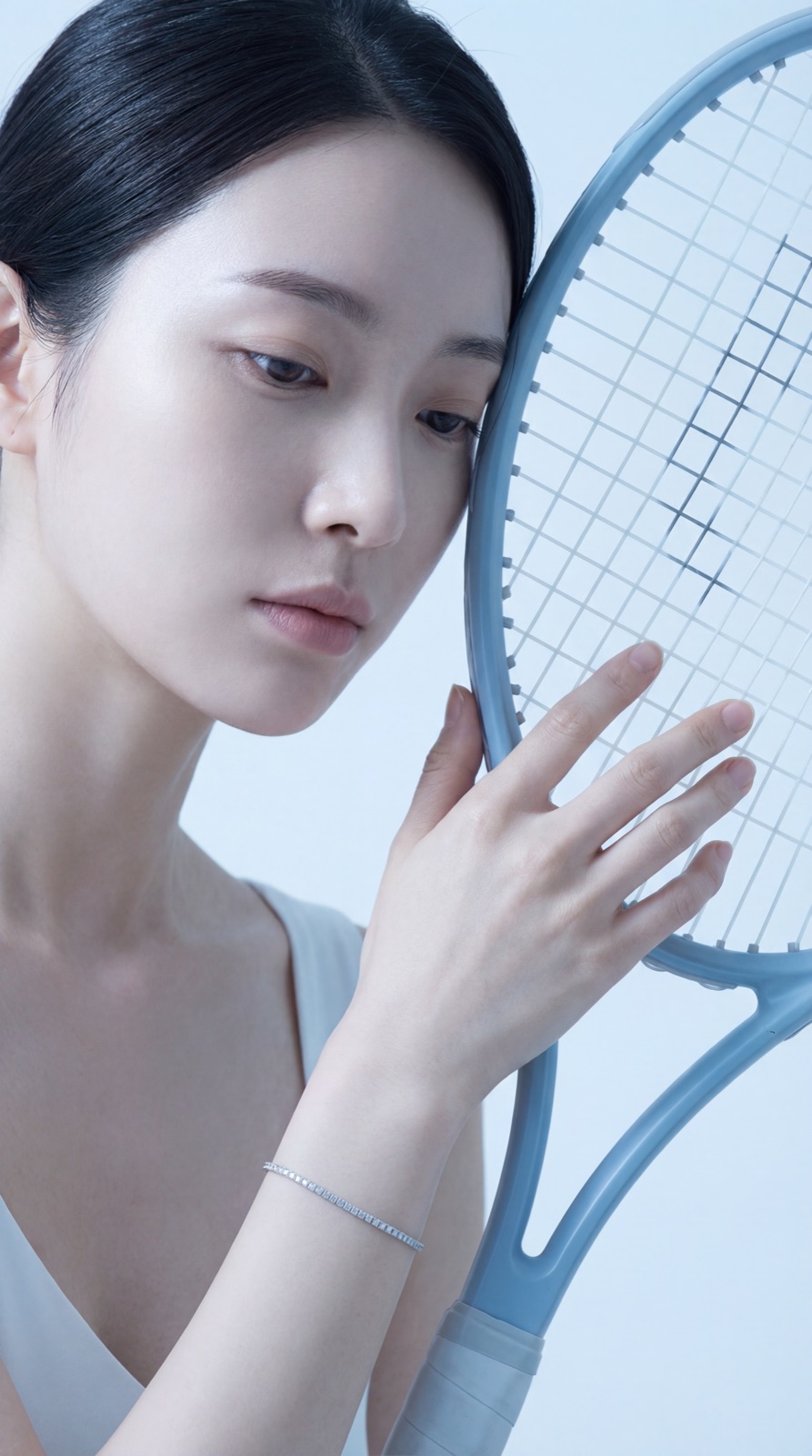Model with racquet to face